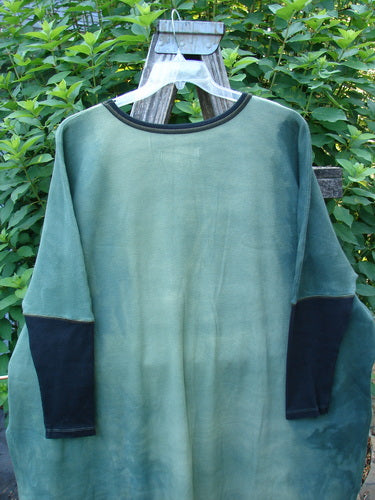 Barclay Thermal Contrast Revival Top in Mottled Field Moss displayed on a hanger, featuring ribbed sleeves and neckline, with a distinct A-line shape highlighting its unique design.