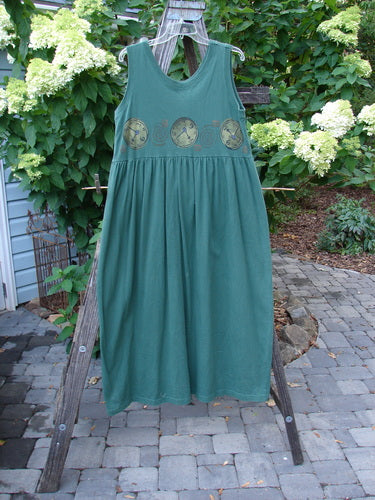 1997 Alcove Jumper Time Verdigris Altered Size 1 displayed on a wooden stand, showcasing its wide sweeping hemline, empire waist seam, and primitive theme paint accents.