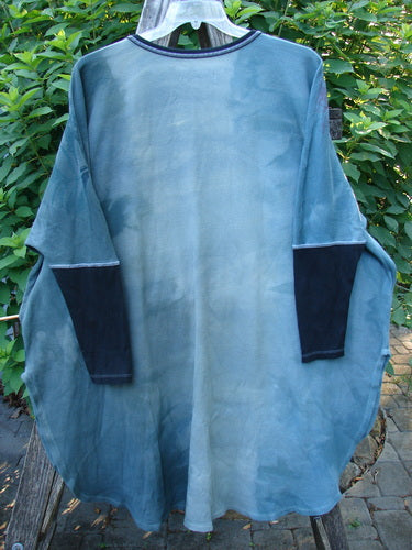 Barclay Thermal Contrast Revival Top in Dusky Dusk displayed on a hanger, showcasing its ribbed tapering sleeves, rounded neckline, and side vents, embodying the creative freedom ethos of BlueFishFinder.com.