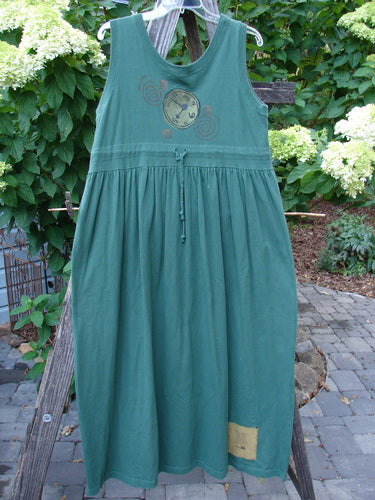 1997 Alcove Jumper Time Verdigris Altered Size 1 hanging on a clothesline, showcasing its empire waist, wide sweeping hemline, and primitive theme paint.