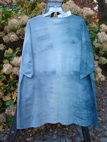 Barclay NWT Art Top: A mannequin wearing a blue shirt with a botanical tree design, featuring a clouded background.