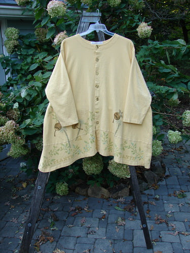 1998 Botanicals Orchard Jacket Vine Pod Sundial Size 2 displayed on a hanger, showcasing its A-line hem, drop shoulders, and unique vine and pod detailing, embodying vintage Blue Fish Clothing's creative expression.