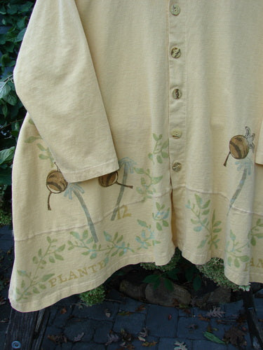 1998 Botanicals Orchard Jacket Vine Pod Sundial Size 2, showcasing a close-up of the organic cotton fabric with detailed vine and pod pattern, rounded neckline, and elegant pearl buttons.