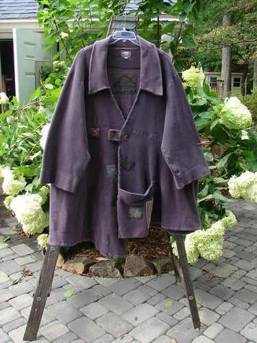 2000 PMU Celtic Moss Highlander Coat Aubergine Size 1 on a rack, showcasing oversized buttons, multiple patches, and a big collared front with tabbed closures.