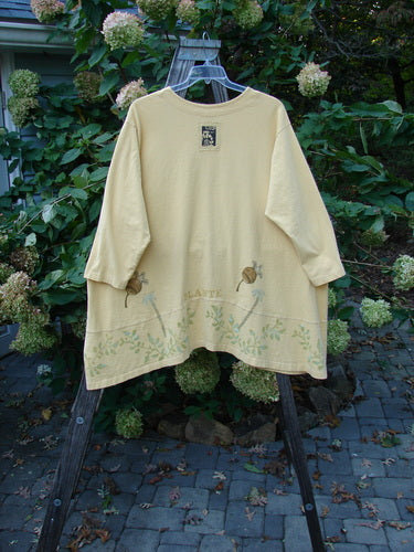 1998 Botanicals Orchard Jacket Vine Pod Sundial Size 2 displayed on a wooden swing, featuring a button-down design, wide banded A-line hem, and detailed vine and pod theme with signature Blue Fish patch.