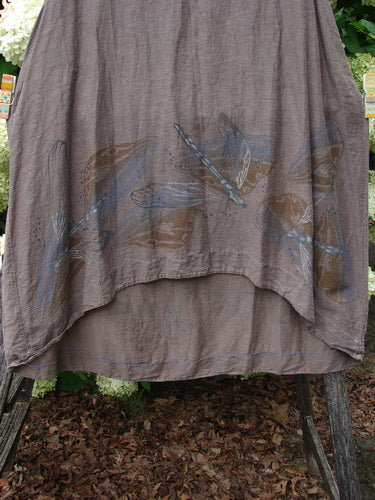 Barclay Hemp Cotton Silk Voile Venetian Pinafore Dragonfly in mocha, size 0, with a soft sheer drape and layered hem. The lightweight hemp-cotton-silk voile shows a muted dragonfly motif in blue and brown across the front.