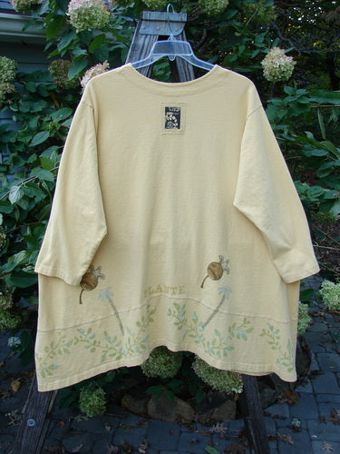 1998 Botanicals Orchard Jacket Vine Pod Sundial Size 2 displayed on a hanger, showcasing its long sleeves, button-down design, wide banded A-line hem, and detailed vine and pod pattern.