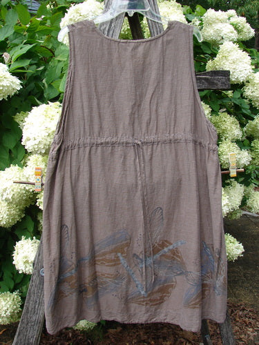 Barclay Hemp Cotton Silk Voile Venetian Pinafore Dragonfly in mocha, size 0, a sleeveless, softly draped dress with a round neckline and gathered waist. The hemp-cotton-silk voile has a muted matte texture, and dragonfly motifs trail across the lower hem in layered blue-brown tones.