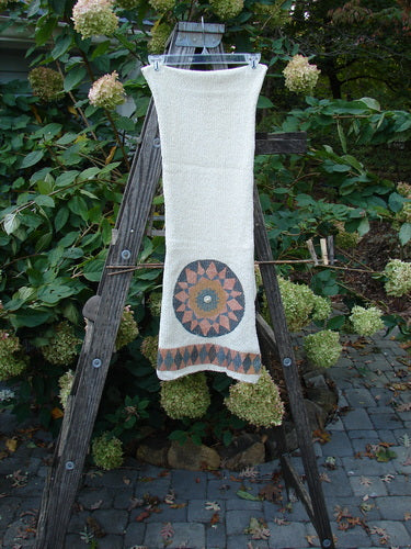 1991 Limited Edition Chenille Knit Scarf Medallion Natural OSFA draped elegantly on a wooden ladder, showcasing its unique drape flow, geometric patterns, and distinctive medallion accents.