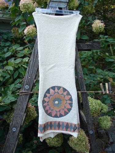 1991 Limited Edition Chenille Knit Scarf Medallion Natural OSFA draped on a wooden ladder, showcasing its unique drape flow, medallion accents, and rolled edges, embodying vintage Blue Fish Clothing's creative expression.