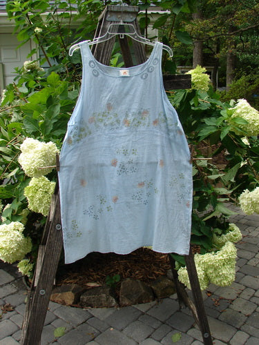 Barclay Batiste Short Tunic Tank Continuous Tiny Floral Birdsong Size 1 displayed on a wooden stand, showcasing its rounded neckline, widening lower, and unique tiny floral pattern.