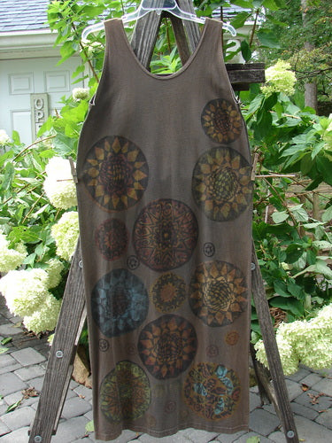 1992 Holiday Sleeveless Column Dress Giant Metallics Grey Sand OSFA displayed on a wooden ladder, featuring a scooped neckline, straight fall, and prominent metallic pinwheel design.