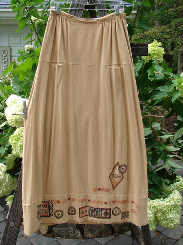 1998 Scrabble Skirt Games Bamboo Size 2: Beige skirt with a design, flat-folded waist, elastic rear, horizontal panels, finger pockets, classical games theme, and wider sweep.