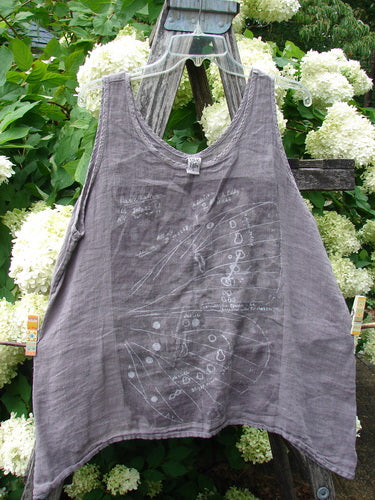 Barclay Linen Altoll Top Wing Stats Rose Quartz Size 0 in muted rose quartz linen, a sleeveless top with a rounded neckline, loose drape, and a faint winged graphic across the front, hanging from a clear hanger amid white hydrangeas and green foliage.