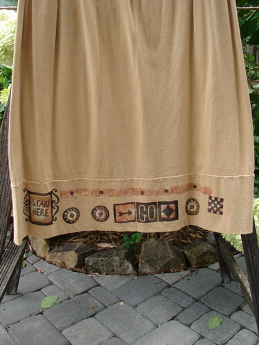 1998 Scrabble Skirt Games Bamboo Size 2, featuring a flat folded waistline, horizontal panels, and two upper pockets, displayed draped over a chair, highlighting the skirt's elegant flow and design.