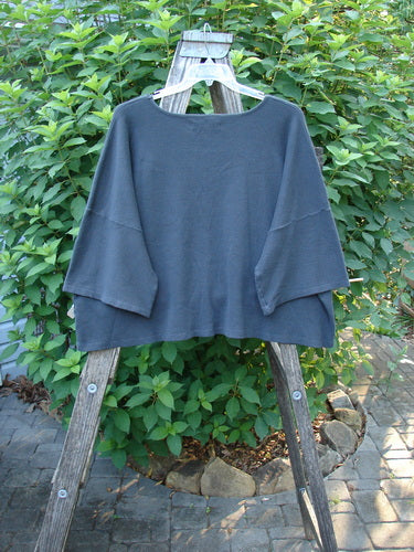 Barclay Thermal Boxy Crop Top Windy Garden Raven OSFA displayed on a wooden ladder, showcasing its waffle texture, three-quarter sleeves, and rounded neckline, embodying BlueFishFinder's vintage, expressive style.