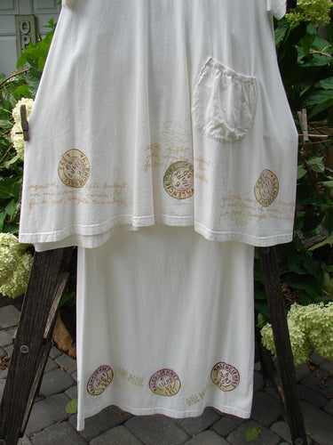 2000 NWT June Straight Duo Postage White Size 2 featuring a white dress with postage-theme paint, front pouch pocket, and matching straight skirt with full elastic waistband adorned with similar patterns.