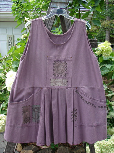 1995 Denim Invention Smock Modern Lolly Flower Heliotrope OSFA on a clothes rack, showcasing front pleats, scooped pockets with rivets, and a painted tunnel pocket.