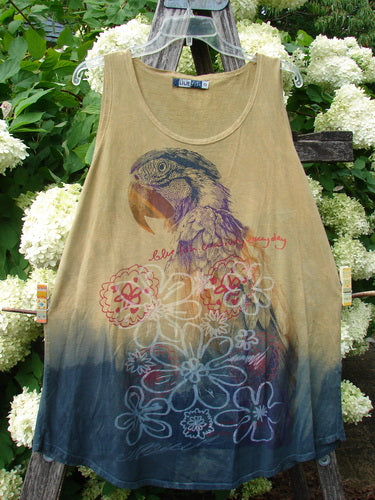 Barclay Round Bottom Tunic Tank Top in mottled golden sunset, size 0, with a sleeveless scoop neckline and a rounded hem that fades from warm tan to deep indigo. A large parrot graphic and layered floral motifs spread across the front in soft, weathered colors.