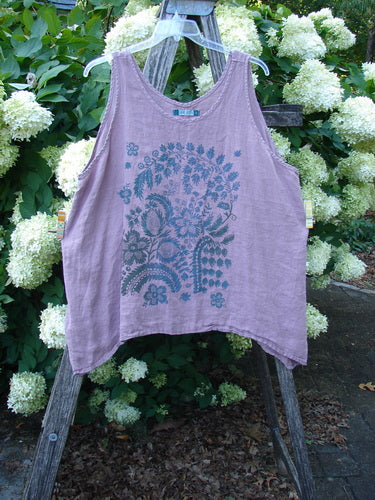 Barclay Linen Altoll Top Victorian Garden Peony Size 2 in dusty lavender linen, a sleeveless tank with a loose drape and curved hem. A teal Victorian garden peony print centers the front, hanging on a clear hanger against white blossoms and greenery.