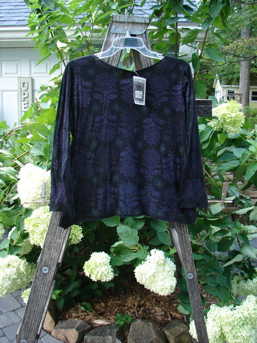 Barclay NWT Batiste Long Sleeved Pullover Fan Floral in Black on a wooden rack, showcasing delicate floral detailing and a price tag.