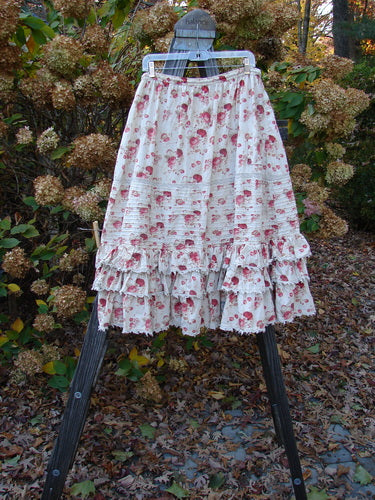 Magnolia Pearl Penelope Skirt with floral print, drawstring waistline, pin tuck accents, lacy ruffles, and lace sections.