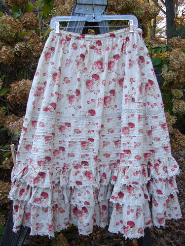 Magnolia Pearl Penelope Skirt with Des Rosier Floral Print, featuring a drawstring waistline, horizontal pin tuck accents, lacy ruffles, and lace sections.