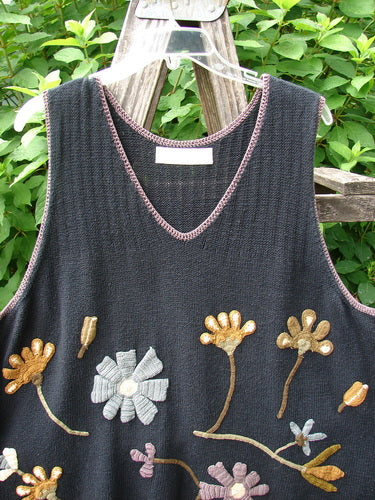 1998 Limited Edition Peruvian Embroidered Sweater Vent Tunic Floral Vine Black OSFA features intricate floral vine embroidery and contrasting whip stitching on a soft cotton knit, displayed gracefully on a wooden surface.
