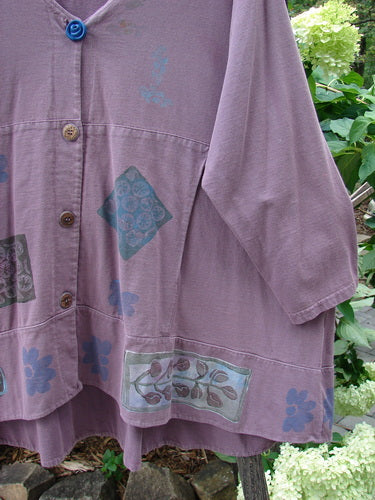 1993 Modernismo Cardigan Nature Plum Wine Size 2 featuring a floral design, old-timey buttons, kangaroo pockets, A-line swing, drawcord back, and oversized signature patch.