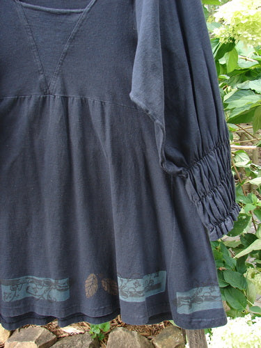 Close-up of the 1993 Juliet Dress Leaf and Vine Black Size 1, showcasing the detailed leaf and vine design, renaissance-style sleeves, and rectangular neckline insert.