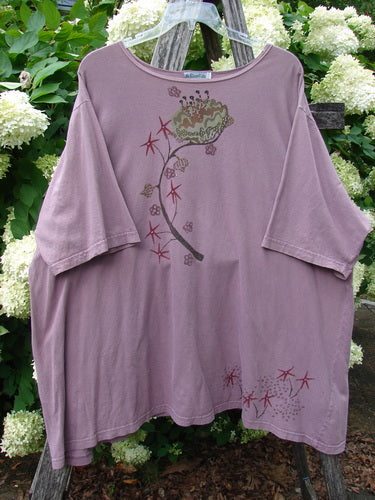 Barclay Short Sleeved Studio Tee Tree Star Laurel Size 3 in dusty mauve, a loose short-sleeved tee with a wide crew neckline and soft cotton knit. A tree-and-laurel graphic runs down the front, with small star motifs near the hem.