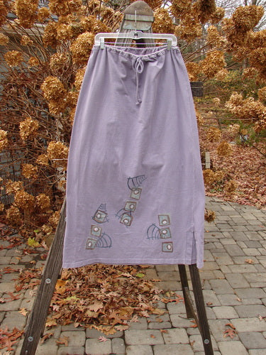 1996 Reprocessed Drawcord Skirt on rack, with full drawcord waist, rectangular shape, 6" side vents, and modern faces design. Size 2.