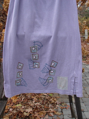 1996 Reprocessed Drawcord Skirt in Mulberry, Size 2: A purple towel with blue squares and squares drawn on it, hanging on a clothesline.