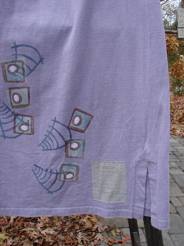 1996 Reprocessed Drawcord Skirt in Mulberry, Size 2: A purple cloth with modern faces on a clothesline.