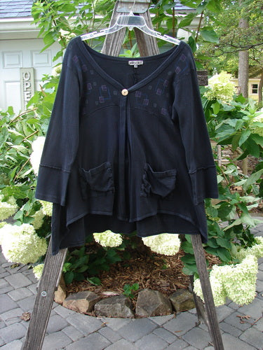 Barclay Patched Thermal Single Button Cardigan Tiny Square Black Size 0 on a wooden rack, showcasing a single wooden button closure and exterior curved stitchery.