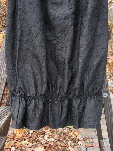 2000 Shaunting Crushed Silk Skirt, black, size 2, on a wooden ladder