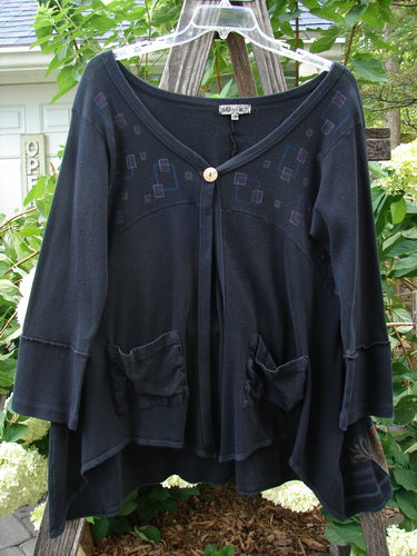 Barclay Patched Thermal Single Button Cardigan Tiny Square Black Size 0 displayed on a clothes rack, showcasing its single wooden button closure, exterior curved stitchery, and two exterior drop front pockets.