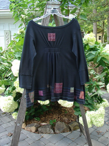 Barclay Patched Thermal Single Button Cardigan Tiny Square Black Size 0 displayed on a wooden rack, featuring a single wooden button closure, exterior curved stitchery, and two drop front pockets.