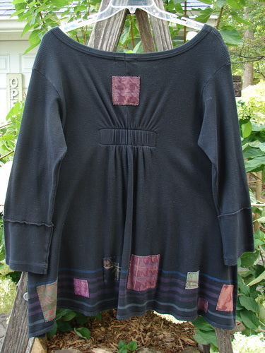 Barclay Patched Thermal Single Button Cardigan Tiny Square Black Size 0 displayed on a clothes rack, showcasing patchwork designs, single wooden button closure, and two front pockets with curved stitchery.