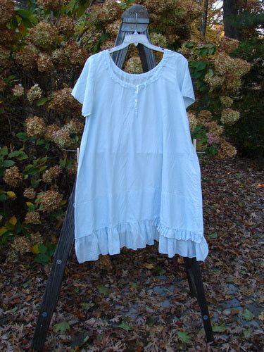Magnolia Pearl Voile Tie Neck Peasant Tunic, Crystal Blue. Featherweight cotton dress on a clothesline with ruffled hem and love theme patch.