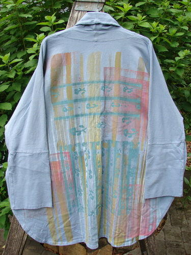 Barclay NWT Reprocessed One Button Golden Hour Jacket displayed on a rack, showcasing its unique flowing design, dolman shoulders, vertical rear paint theme, and oversized diagonal pockets, embodying Bluefishfinder.com's vintage appeal.