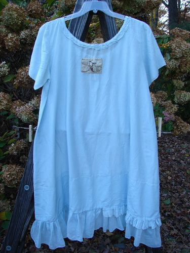 Magnolia Pearl Voile Tie Neck Peasant Tunic Crystal Blue OSFA: A blue dress with ribbon tie neckline, short sleeves, and ruffled lower hem.