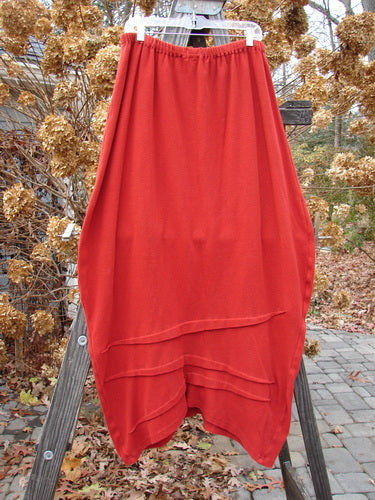 2000 Thermal Awen Skirt on a wooden ladder, with a textured diagonal hemline and interesting folds of fabric. Size 2.