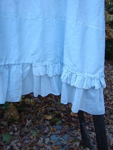 Magnolia Pearl Voile Tie Neck Peasant Tunic - Close-up of dress with ribbon tie neckline, short sleeves, and ruffled lower hem.
