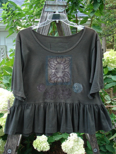 1992 Holiday Short Sleeved Peplum Top Black Sand Size 1 displayed on a hanger, highlighting its ribbed neckline, drop shoulders, and peplum lower in perfect condition.