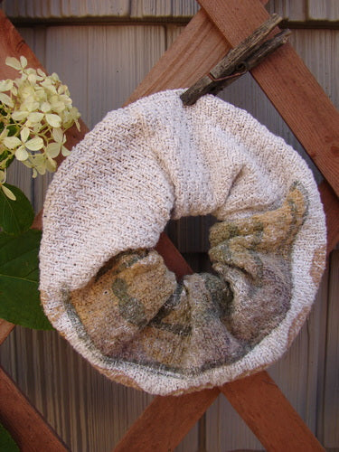 1994 PMU Cotton Knit Hair Scrunchie Garden Path Natural One Size displayed on a wooden fence, showcasing its thick cotton knit texture and ruffled design, illustrating Bluefishfinder.com's commitment to sustainable vintage fashion.