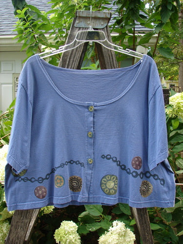 1993 Travel Top Pinwheel Periwinkle Size 2 featuring a deeply scooped neckline, crop shape, chain and pinwheel design, and rare ceramic buttons.