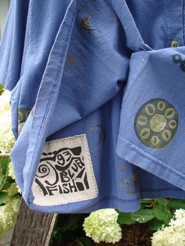 1993 Travel Top Pinwheel Periwinkle Size 2 featuring a deeply scooped neckline, crop shape, Blue Fish 93 patch, and rare ceramic buttons, perfect for layering and collecting.