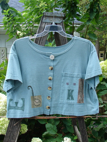 1994 Song Top Multi Letter K Ice Size 1 features a wide, boxy shape, shallow neckline, vintage buttons, an oversized painted front pocket, and a signature Blue Fish patch.