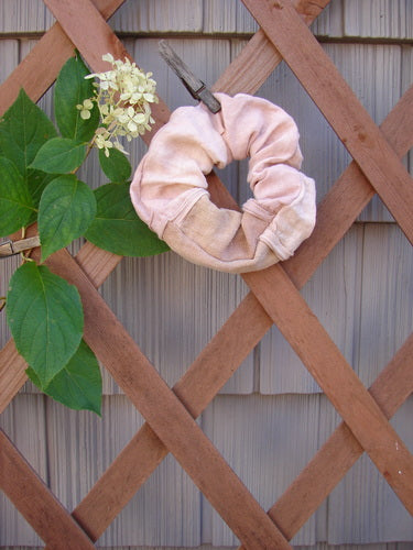 Barclay PMU Linen Hair Scrunchie Unpainted Textured Mauve One Size, displayed on a wooden lattice, showcasing its ruffled fabric and thin elastic band, reflecting Bluefishfinder.com's commitment to vintage-inspired sustainability.